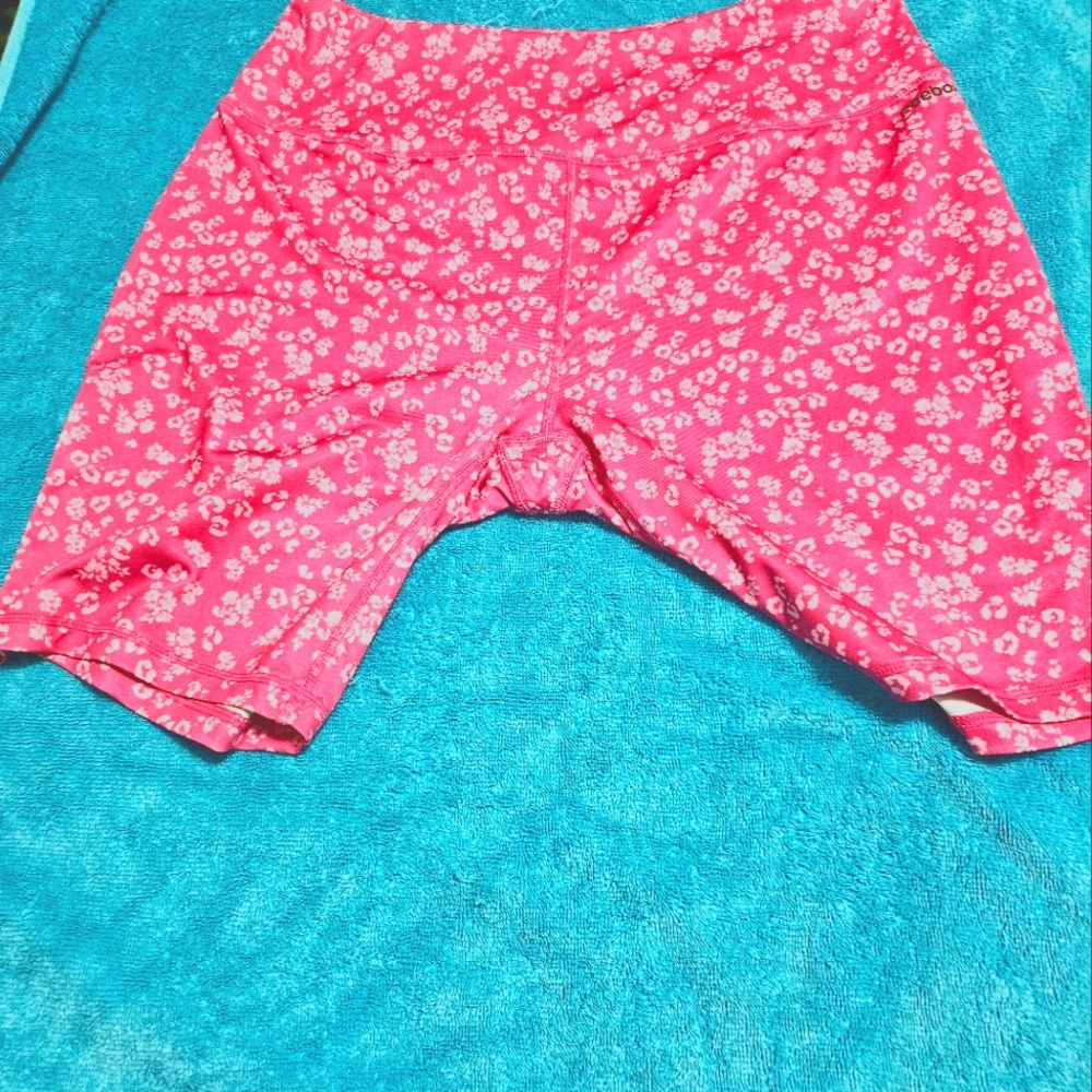 These are XL and Reebok work out shorts. They are a pretty pink and white.